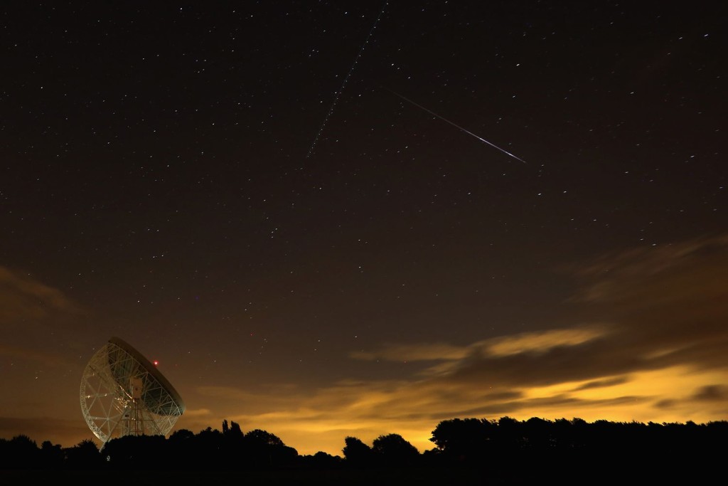 HOLMES CHAPEL, UNITED KINGDOM - AUGUST 13: A Perseid meteor streaks across the sky over the Lovell Radio Telescope at Jodrell Bank on August 13, 2013 in Holmes Chapel, United Kingdom.The annual display, known as the Perseid shower because the meteors appear to radiate from the constellation Perseus in the northeastern sky, is a result of Earth's orbit passing through debris from the comet Swift-Tuttle. (Photo by Christopher Furlong/Getty Images)