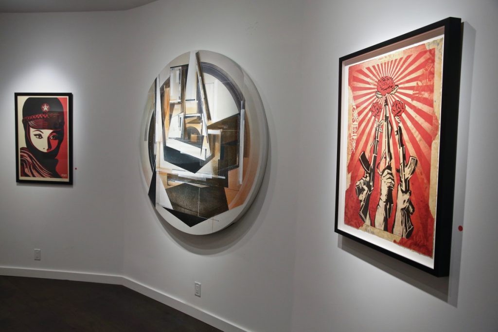 From left, Mujer Fatale by Shepard Fairey, Unfolding Season by Augustine Kofie, and Guns and Roses by Shepard Fairey from Composure: A Street Art Narrative curated by Todd Mazer at Pellas Gallery